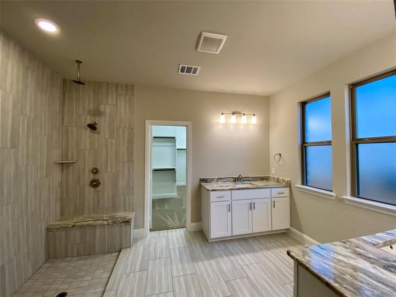 Master bathroom with separate white Monet Quartz vanities(not in photo), oversized tile, and HUGE walk-in shower w/ frameless glass not yet installed.