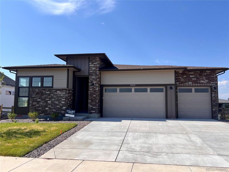 Front exterior of a new home in Kitchel Lake at Serratoga Falls, Timnath, CO, highlighting curb appeal (Image 2).