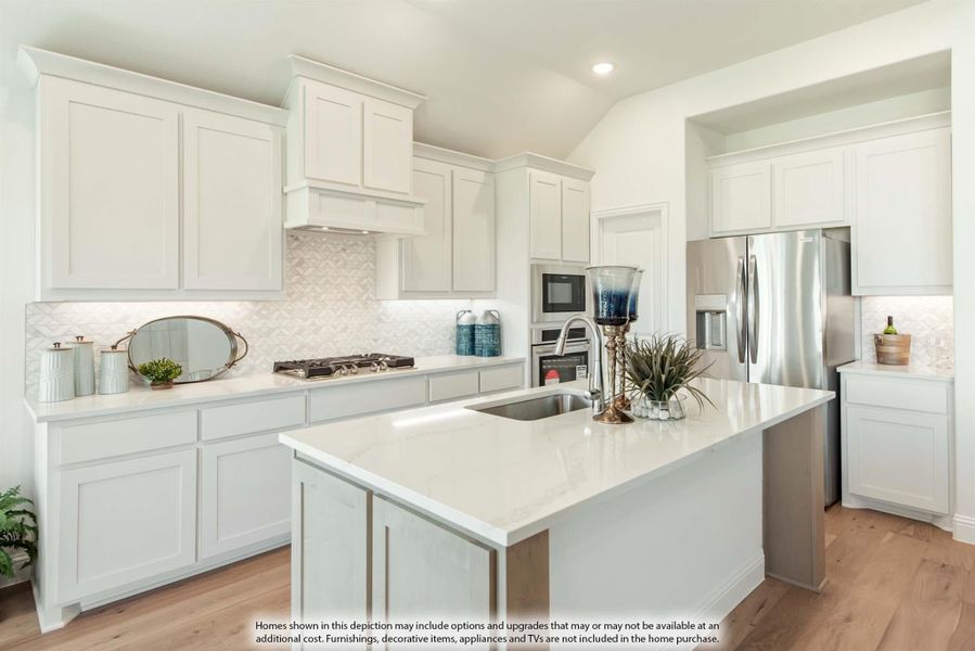 White kitchen with center island, quartz countertops, stainless steel appliances, and light hardwood floors