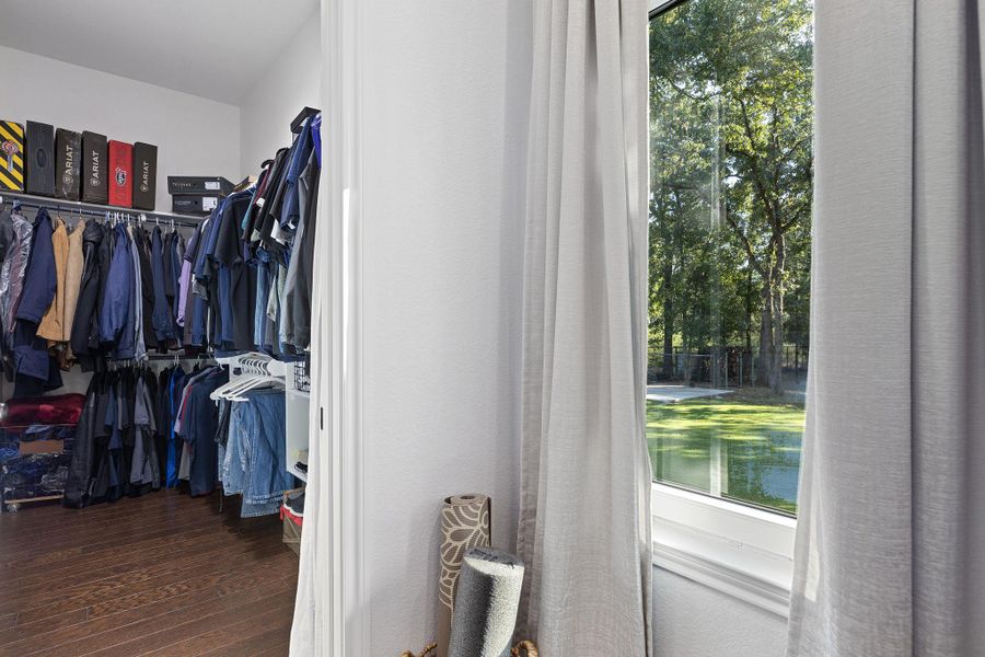 Spacious closet featuring dark wood-type flooring Spacious closet featuring dark wood-type flooring