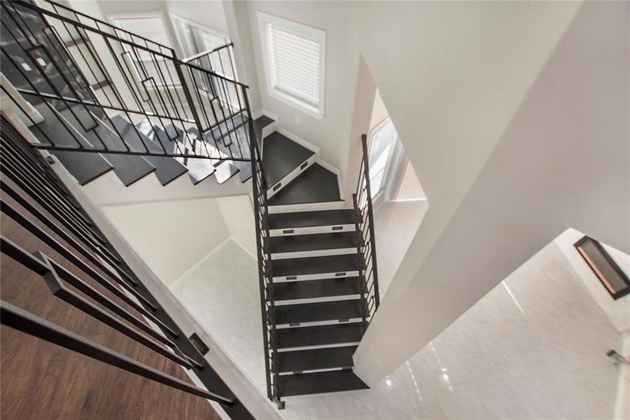 Stairway featuring a towering ceiling Stairway featuring a towering ceiling