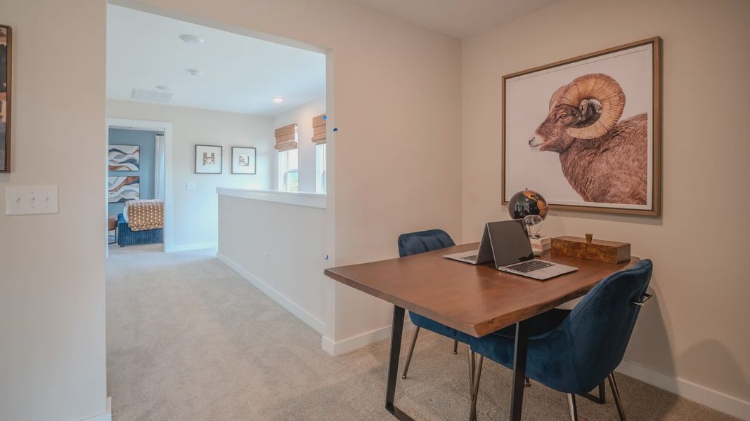 Loft area with opening to hallway leading to staircase