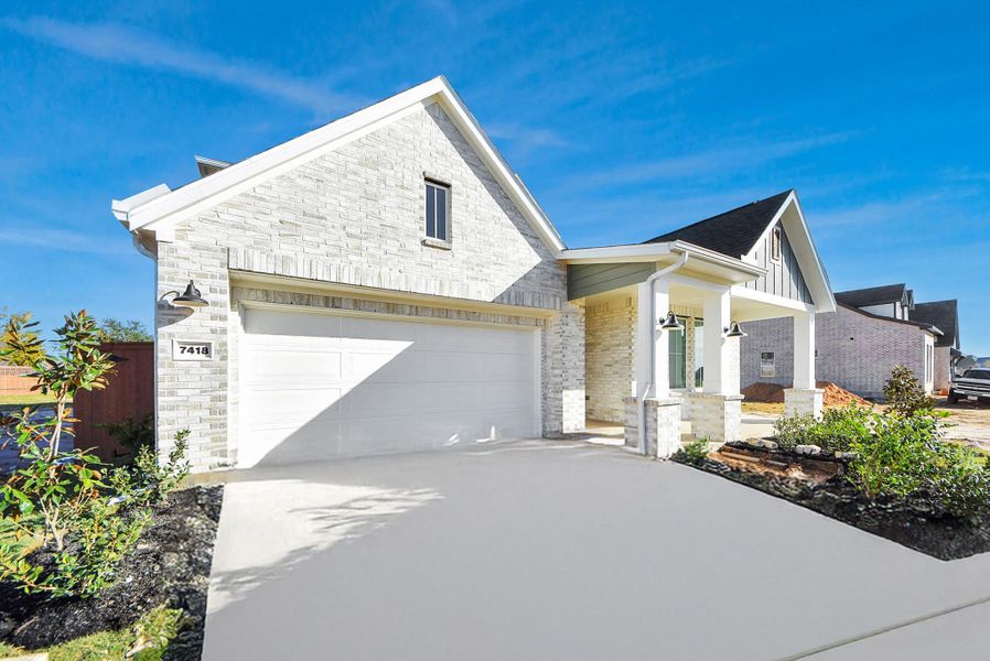 Front exterior of a new home in Elyson, Katy, TX, highlighting curb appeal (Image 26).