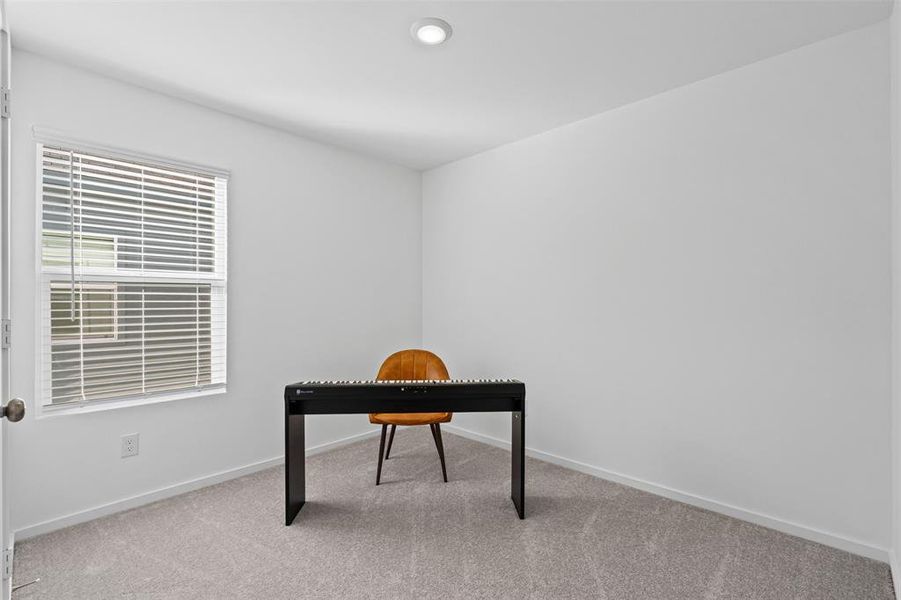 Unfurnished office featuring light colored carpet and baseboards