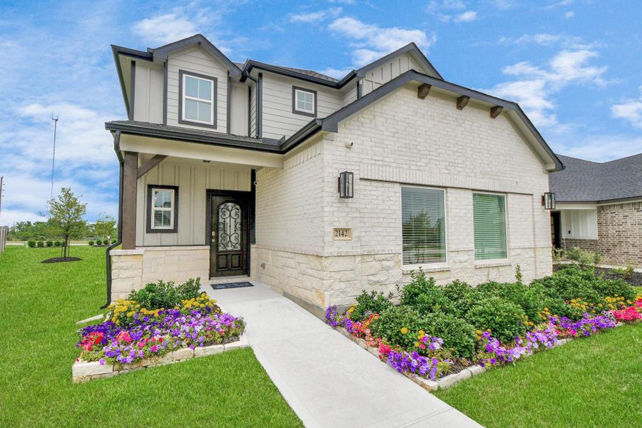 This home boasts lush green grass and meticulous landscaping. Its premium elevation showcases an exquisite blend of brick and stone features, complemented by modern coach lighting This home boasts lush green grass and meticulous landscaping. Its premium elevation showcases an exquisite blend of brick and stone features, complemented by modern coach lighting