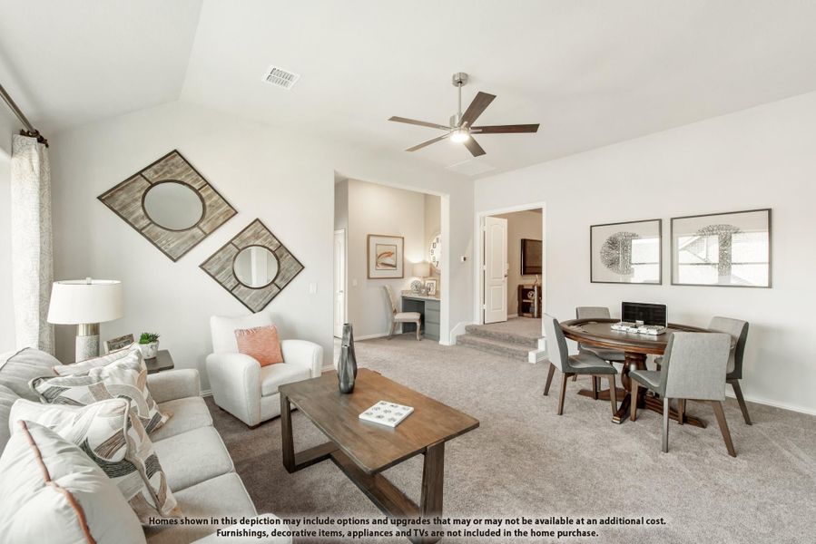 Open living room with carpet, ceiling fan, seating area, and round dining table with chairs