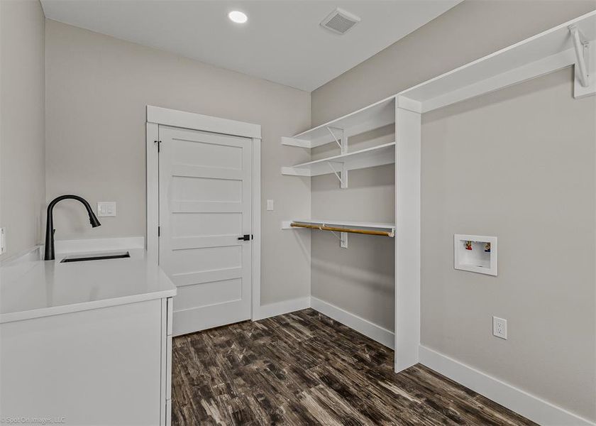 Laundry with storage and sink.