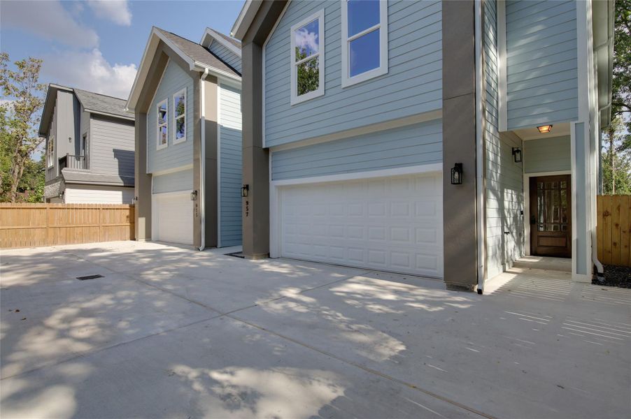 Expansive paved drive with ample guest parkingleads to modern twin homes. Crisp gabled lines,light blue siding, and contemporary sconces. Eachresidence offers an oversized two-car garage and acovered private entry, with a fully fenced yardbeyond. Expansive paved drive with ample guest parkingleads to modern twin homes. Crisp gabled lines,light blue siding, and contemporary sconces. Eachresidence offers an oversized two-car garage and acovered private entry, with a fully fenced yardbeyond.