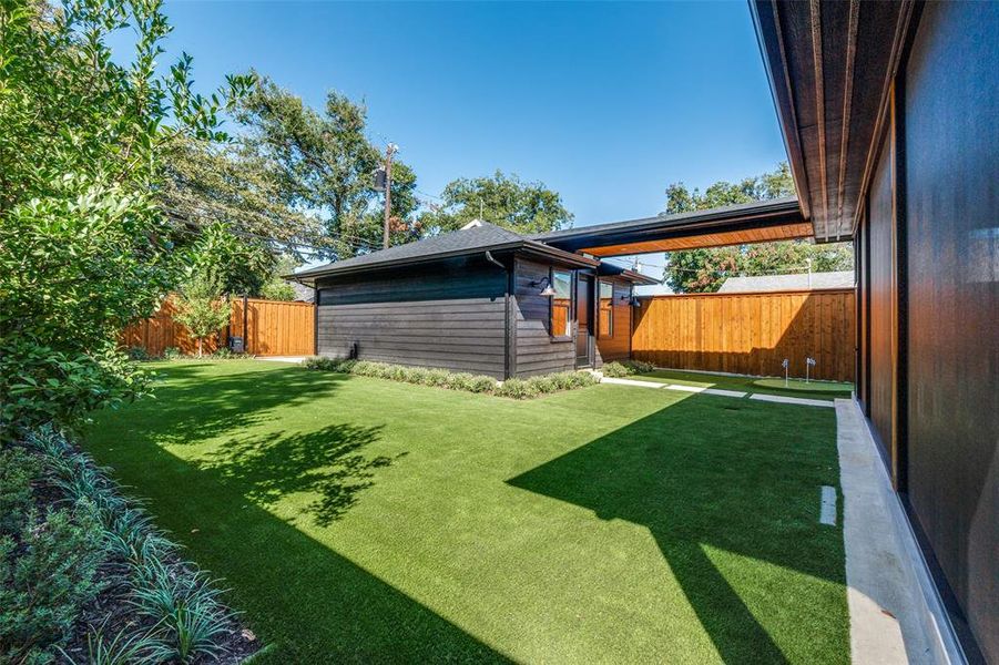 full turfed and landscaped backyard with covered breezeway