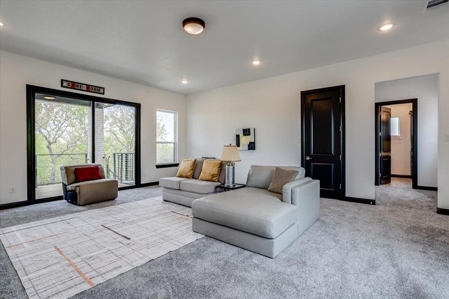 Carpeted living room with baseboards and recessed lighting