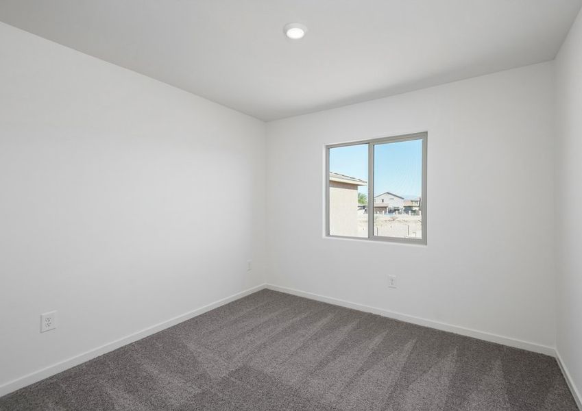 The secondary bedrooms have lots of natural light, creating a warm, inviting atmosphere.