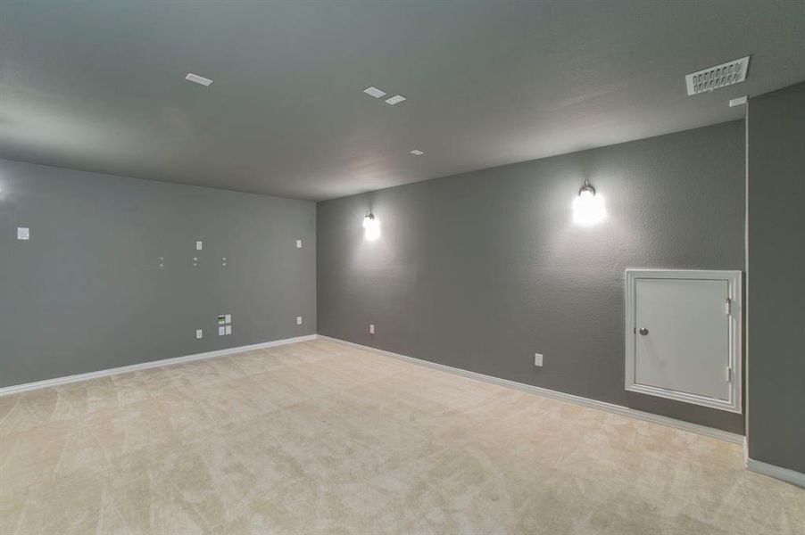 Spare room with light colored carpet and baseboards Spare room with light colored carpet and baseboards