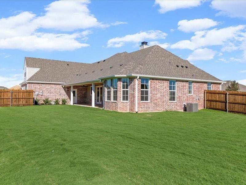 Rear view of property featuring a fenced backyard, brick siding, a patio, and a chimney Rear view of property featuring a fenced backyard, brick siding, a patio, and a chimney