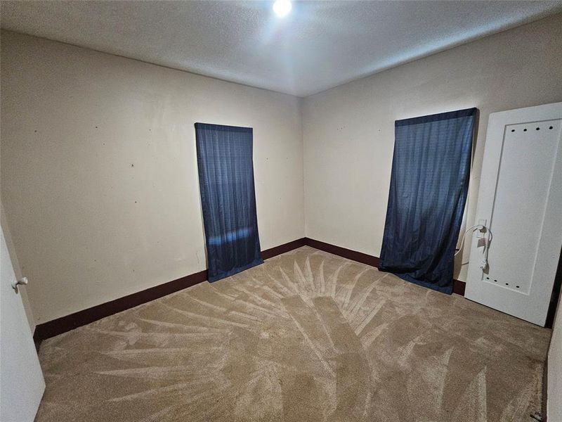 Carpeted spare room featuring a textured ceiling Carpeted spare room featuring a textured ceiling