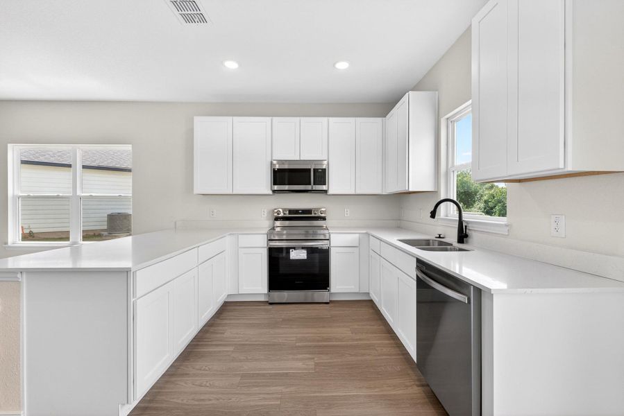 Crisp white cabinetry pairs with quartz countertops