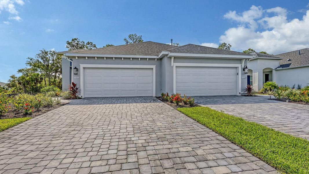 Front exterior of a new home in Wildleaf Real Estate and Homes for Sale in Parrish, FL - Neal Communities, Parrish, FL, highlighting curb appeal (Image 26). Front exterior of a new home in Wildleaf Real Estate and Homes for Sale in Parrish, FL - Neal Communities, Parrish, FL, highlighting curb appeal (Image 26).