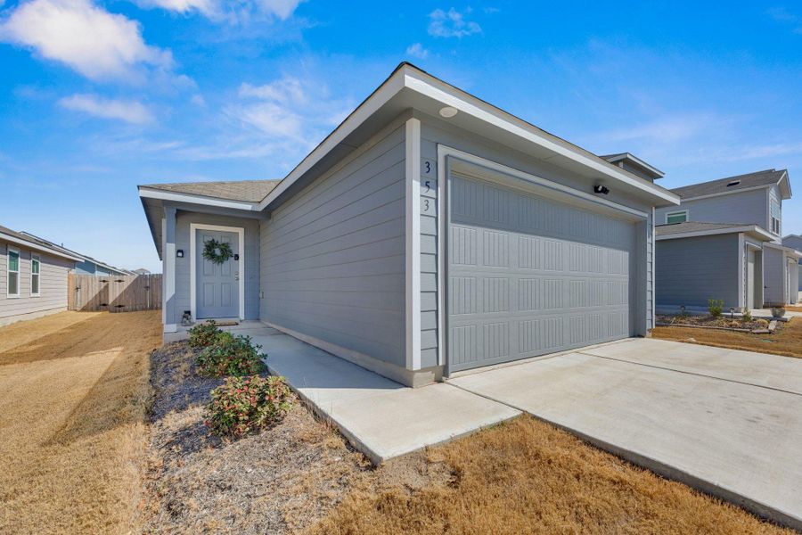 Single story home with two car garage and front porch.