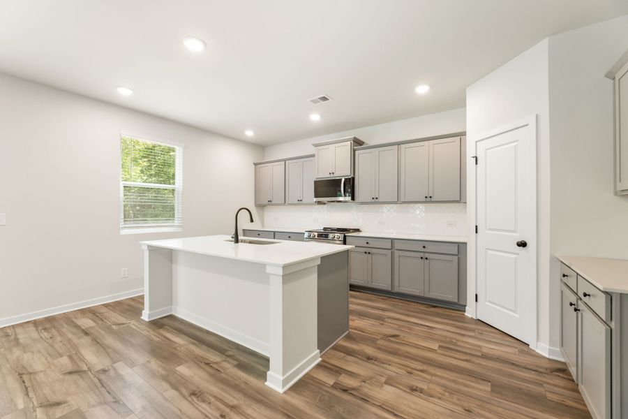 A kitchen with white cabinets. A kitchen with white cabinets.