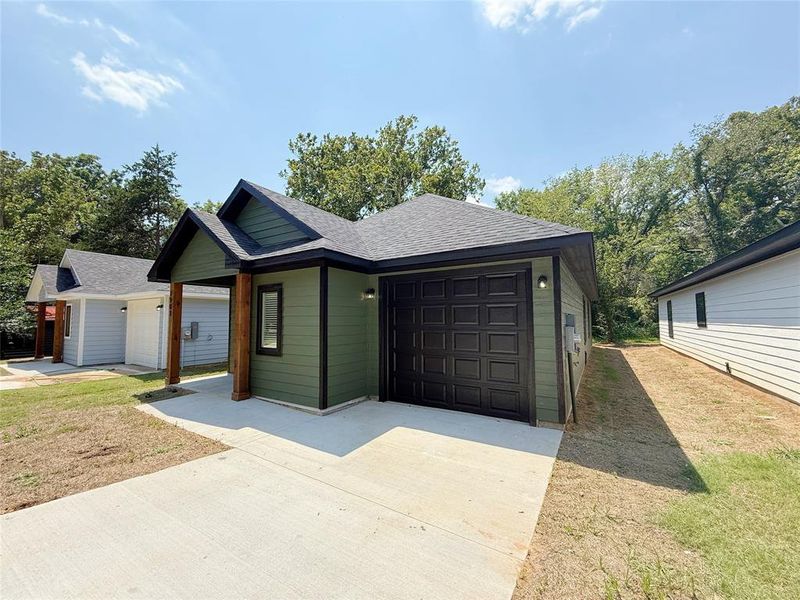 Front exterior of a new home in , Denison, TX, highlighting curb appeal (Image 1).