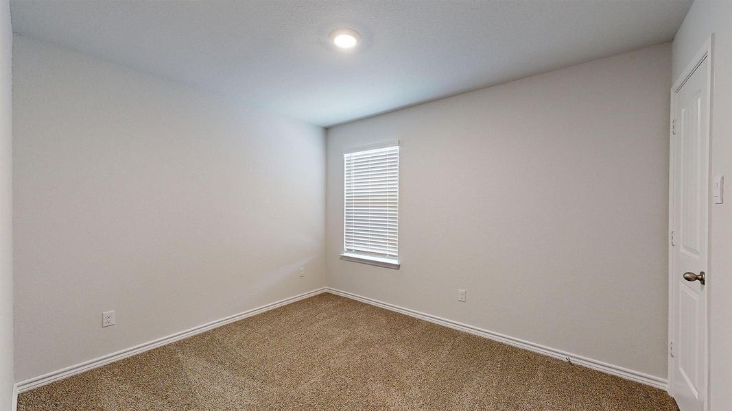 Carpeted empty room featuring baseboards Carpeted empty room featuring baseboards