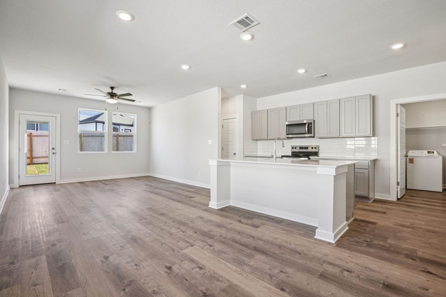 A large kitchen with white cabinets.