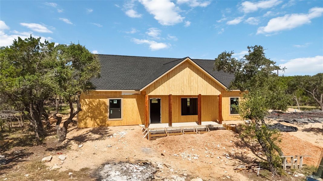 View of front of home featuring a shingled roof and a porch View of front of home featuring a shingled roof and a porch