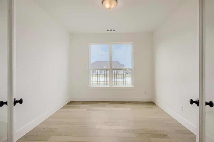 Unfurnished room featuring light wood-style flooring and baseboards