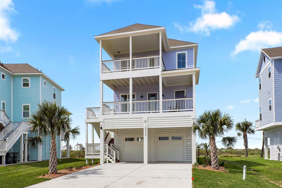 Another perspective of the exterior showcases two of the expansive shaded balconies where you can relax, unwind, and enjoy refreshing Gulf breezes. The layout ensures plenty of space to gather both inside and out.