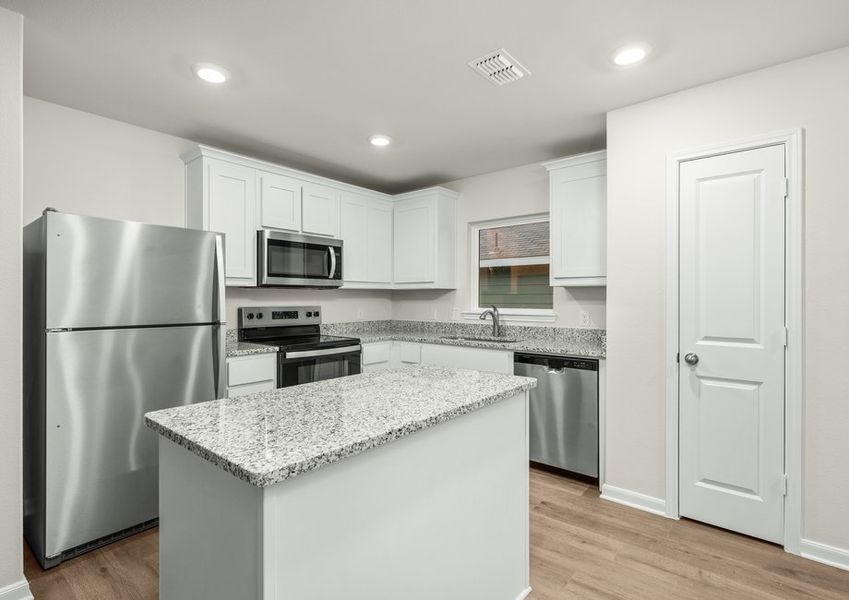 The kitchen has beautiful white wood cabinetry. The kitchen has beautiful white wood cabinetry.