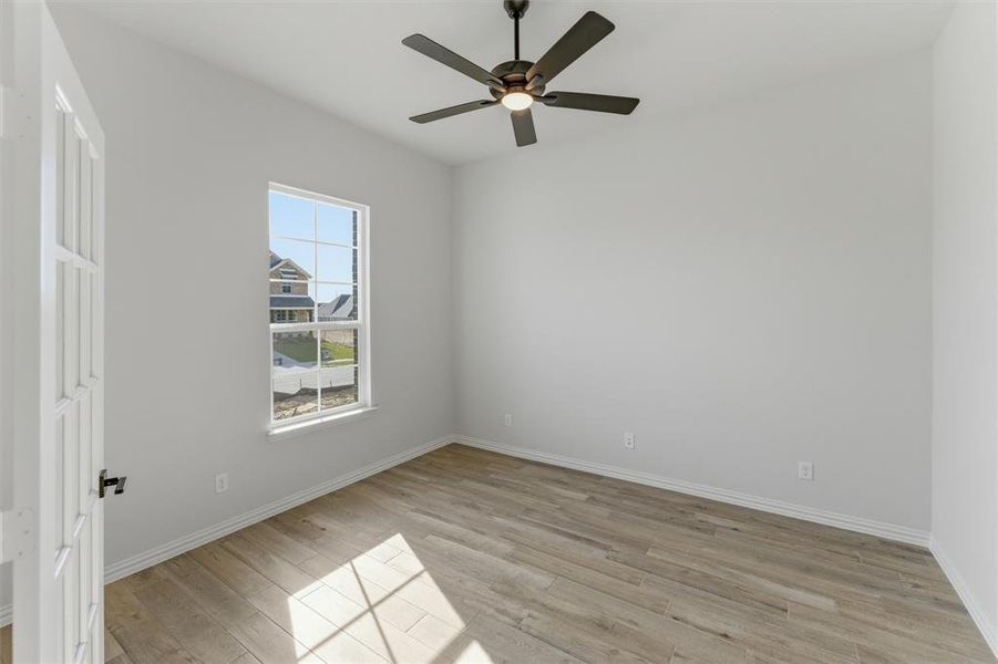 Unfurnished room featuring light wood-style flooring and a ceiling fan