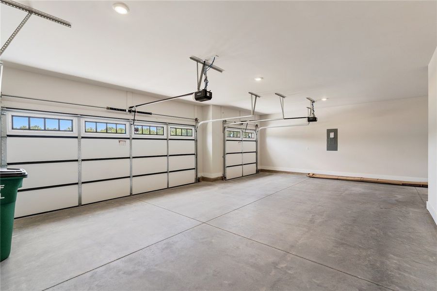 A pristine, oversized garage offers ample space fo