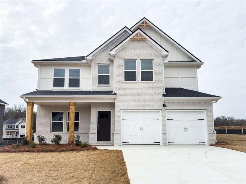 Front exterior of a new home in Conner Springs, Social Circle, GA, highlighting curb appeal (Image 1).