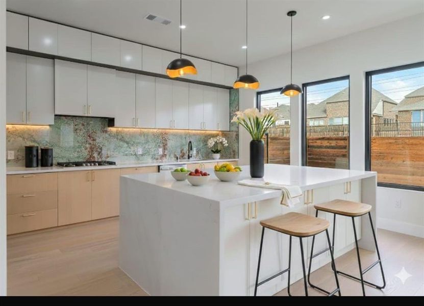 Kitchen featuring hanging light fixtures, a breakfast bar area, recessed lighting, a center island, and modern cabinets