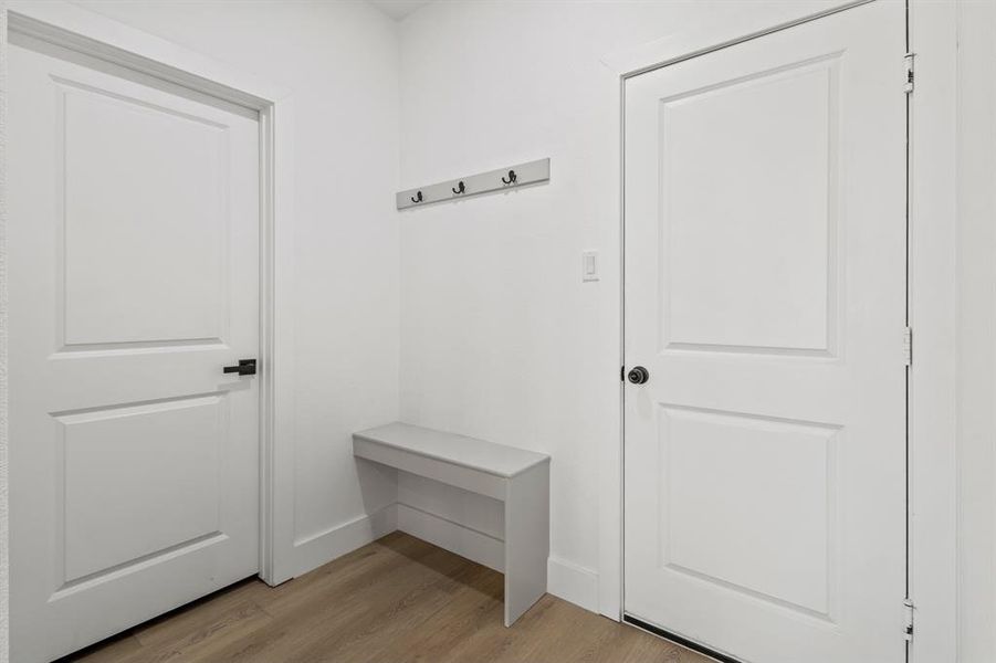 Mudroom with baseboards and light wood-style floors