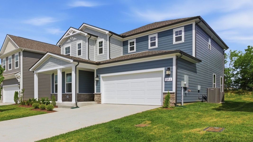 Home exterior with blue siding and two car garage Home exterior with blue siding and two car garage