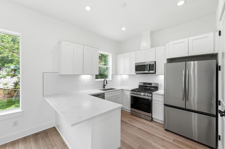 The kitchen you've always wanted is finally here! Quartz peninsula, white shaker cabinets, subway tile backsplash, stainless steel appliances, and gas range make this space as beautiful as it is functional. The kitchen you've always wanted is finally here! Quartz peninsula, white shaker cabinets, subway tile backsplash, stainless steel appliances, and gas range make this space as beautiful as it is functional.