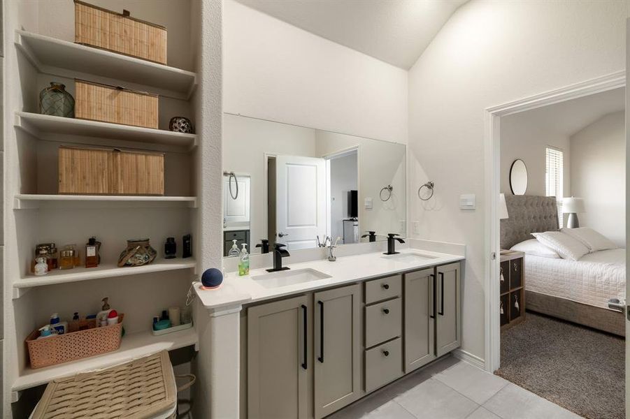 Full bath featuring double vanity, light tile patterned floors, ensuite bath, and light carpet Full bath featuring double vanity, light tile patterned floors, ensuite bath, and light carpet
