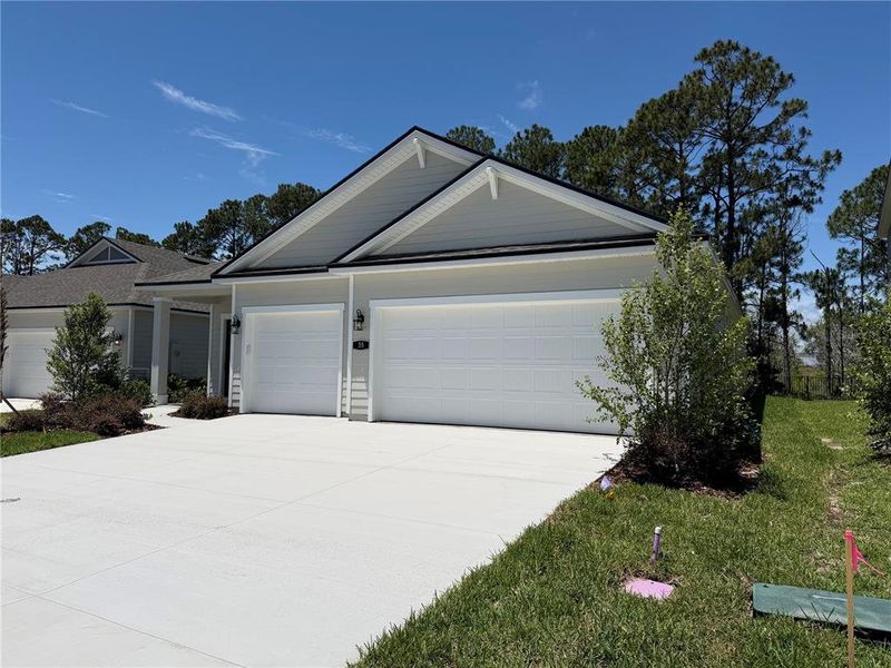 Front exterior of a new home in Reserve East, Flagler Beach, FL, highlighting curb appeal (Image 25).
