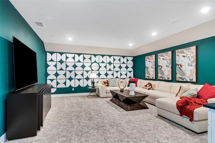 Living area with an accent wall, carpet floors, and recessed lighting Living area with an accent wall, carpet floors, and recessed lighting