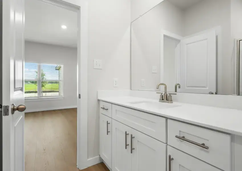 Master bath features beautiful white cabinets.