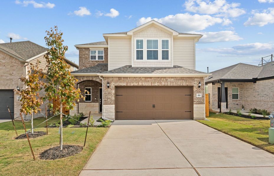 Front exterior of a new home in Crosswinds, Kyle, TX, highlighting curb appeal (Image 18).