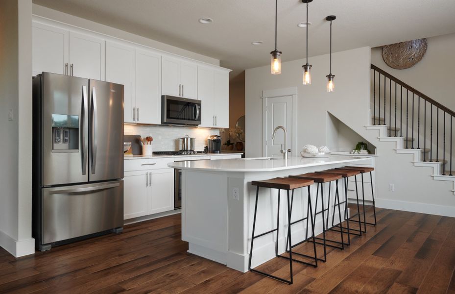 Spacious island kitchen with pendant lighting