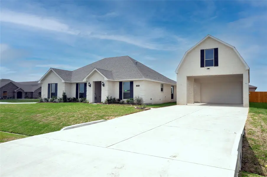 Wide drive to detached garages keep the streets clear.