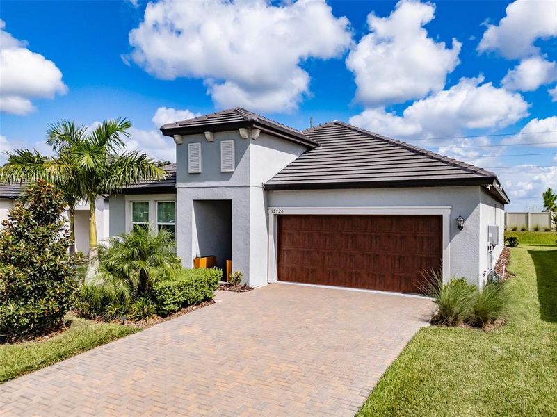 Front exterior of a new home in Prosperity Lakes, Parrish, FL, highlighting curb appeal (Image 25).