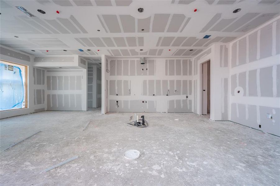 View from primary level living space. Kitchen, dining space, and floor-to-ceiling wine storage.