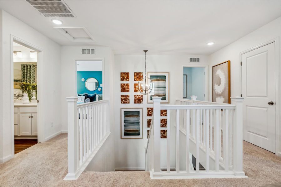 A white room with a white crib and a white railing. A white room with a white crib and a white railing.