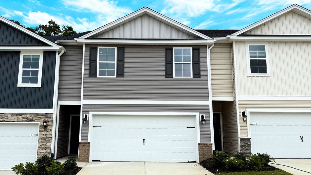 Front exterior of a new home in Brightwood Farm, Whitsett, NC, highlighting curb appeal (Image 1).