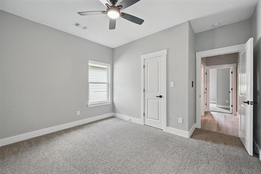 Unfurnished bedroom featuring carpet, baseboards, and ceiling fan