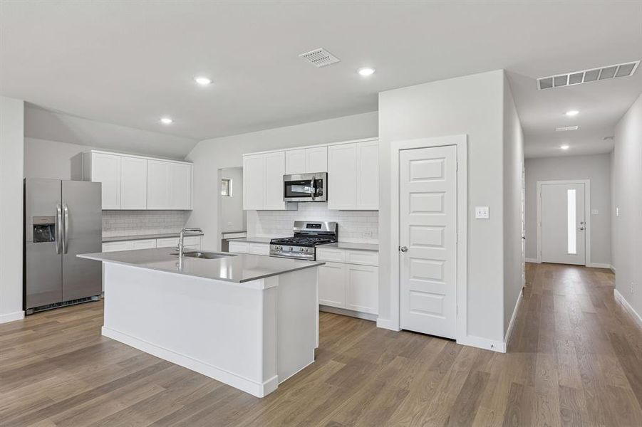 Kitchen in the Harrison home plan by Trophy Signature Homes – REPRESENTATIVE PHOTO