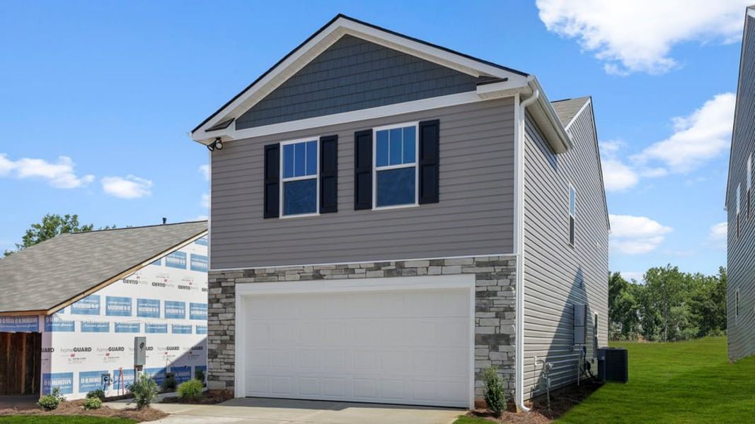 Front exterior of a new home in Trailside Run, Spartanburg, SC, highlighting curb appeal (Image 2). Front exterior of a new home in Trailside Run, Spartanburg, SC, highlighting curb appeal (Image 2).